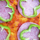 parbaked pizza with sauce, salami, and green pepper rings